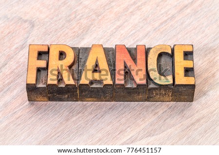 France word in vintage letterpress wood type against grained wood