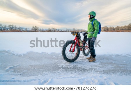 senior cyclist is riding a fat bike in winter, a cold day in Colorado