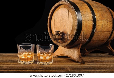 Whiskey and oak barrel on a black background