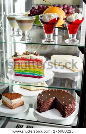 Fridge with fruit cake and desserts
