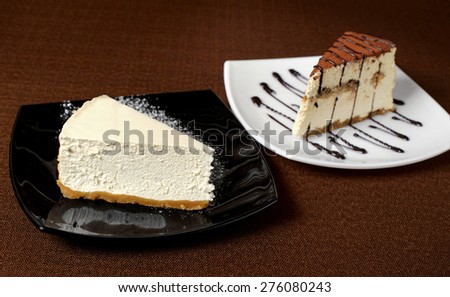 Tiramisu and cheesecake on a dark background. Dessert.