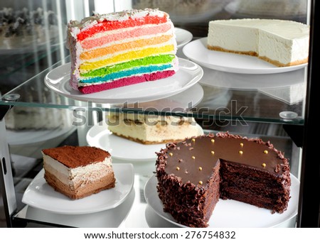 Fridge with fruit cake and desserts