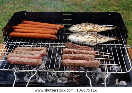 meat and fish on grill