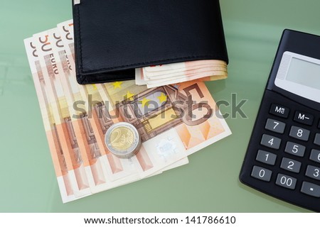 concept of making money with wallet,money,calculator on glass table