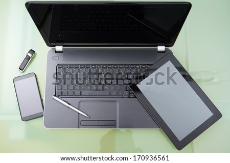 Laptop With Tablet And Smart Phone On Glass Table