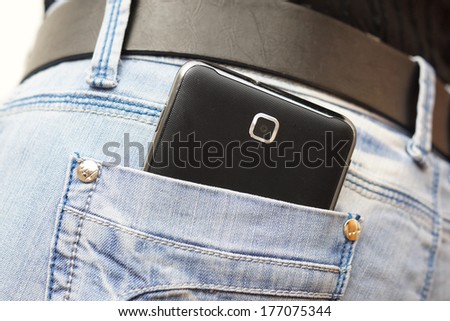 mobile phone in woman jeans pocket
