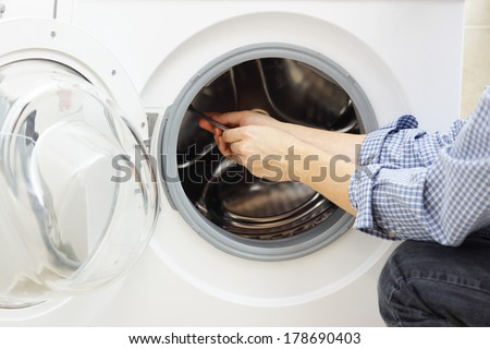 handyman repairing a washing machine
