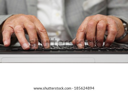 very old woman typing on computer keyboard
