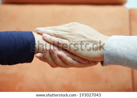 man hands holding  woman hand from both sides. Compassion and  concern concept