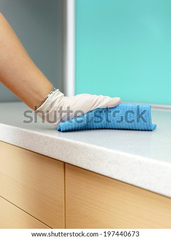 Woman Wearing Apron Cleaning Kitchen counter