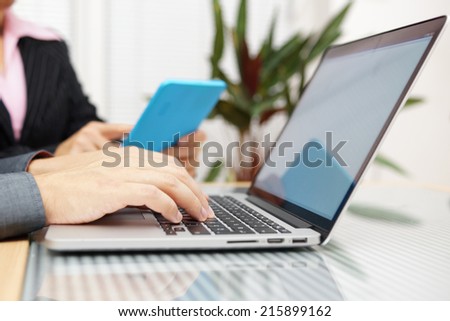 man and woman on business meeting working on tablet pc and laptop