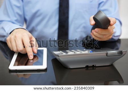 businessman is using tablet pc and calling support