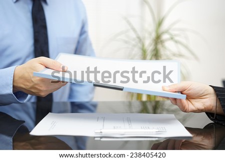 Man and woman are exchanging contract or document