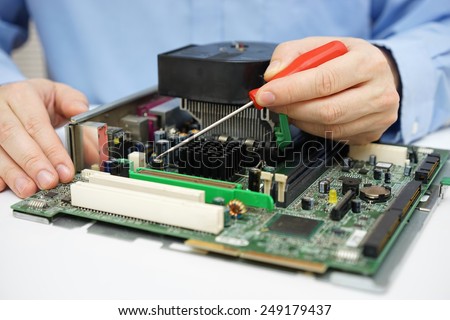 Computer  technician is checking computer motherboard