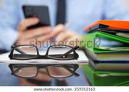 businessman is calling financial adviser for help.Focus on glasses