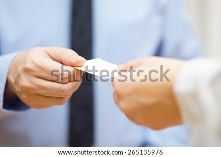 businessman and businesswoman are exchanging business cards