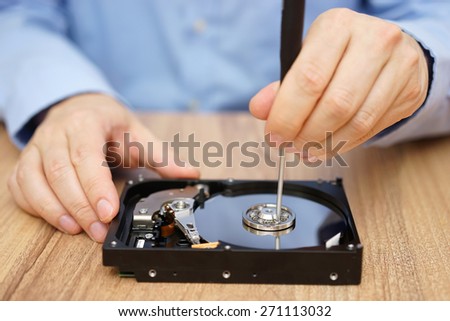 Engineer is recovering data from failed hard disk drive