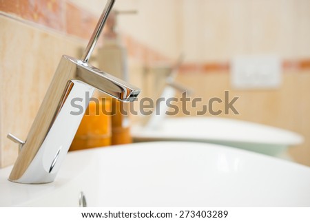 modern bathroom with sink and faucet, blurred background