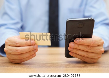 businessman use  contact information from  business card to contact his client