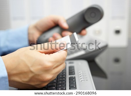 businessman is holding credit card and calling bank for financial services