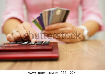 woman calculate how much cost or spending have with credit cards
