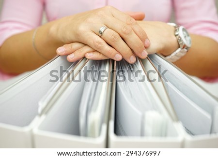 Secretary holding binders, concept of accounting,business,documentation,paperwork