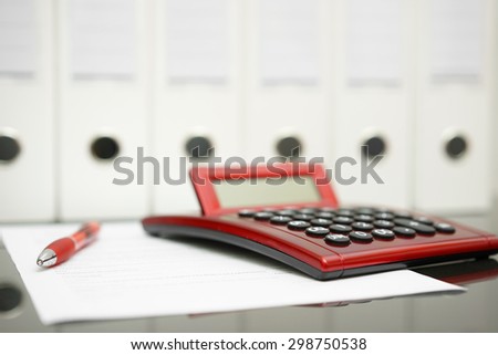 concept of accountant desk with calculator,pen,document and documentation in background