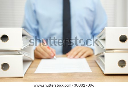 businessman is writing report about 
irregularities in company data