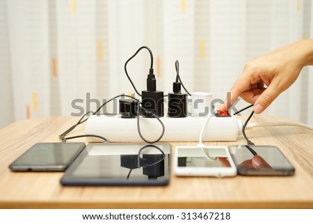 man is turning off  power adapters for mobile phones and tablet computers