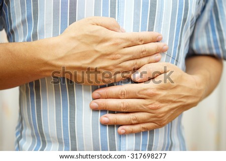 Stomach ache, man placing hands on the stomach, concept of 
stomach ulcer