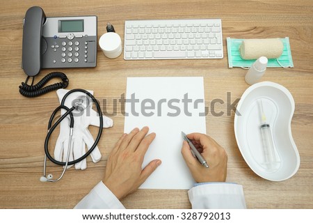 top view of doctor writing medical report