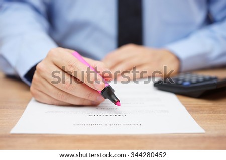 businessman is preparing to examine legal document and highlight important information
