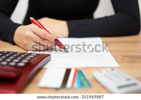 woman is reading bank notice about credit card spending and  repayment of debt