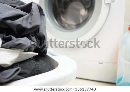 a pile of dirty laundry waiting to be washed in a washing machine
