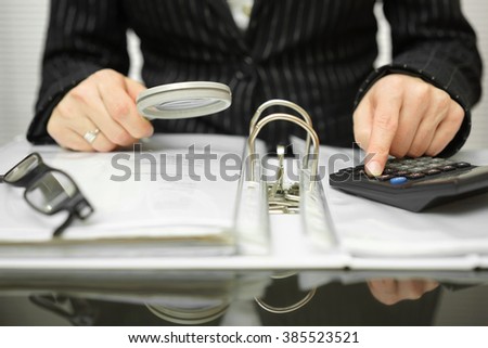 accountant is examining  invoices and documents