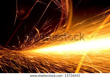 White hot sparks at grinding steel material