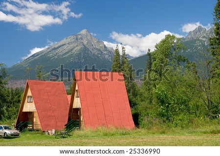 A mountain in the Slovakia during the day and mountain cottage