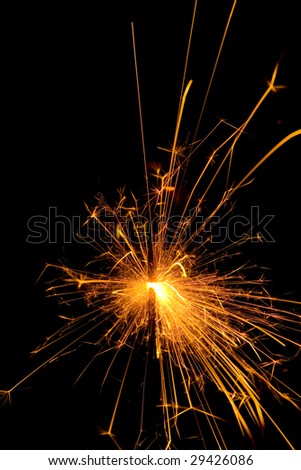 Hot orange burning christmas sparkler at night