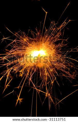 Hot orange burning christmas sparkler at night