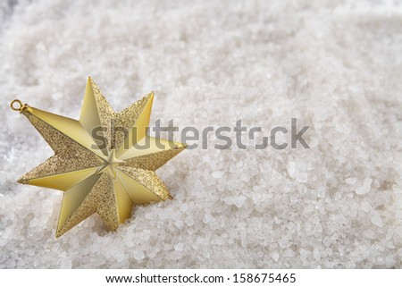 A single Christmas star on a snow background with top down angle
