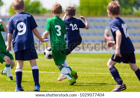 Football Match For Children. Training and Football Soccer School Tournament. Group of Boys Playing Football