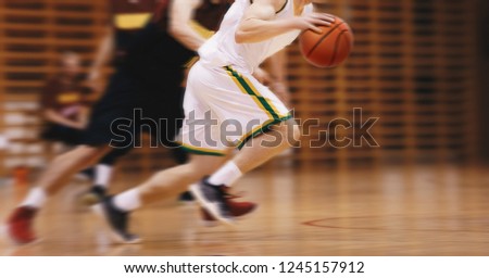Two Young High School Basketball Players Playing Game. Youth Basketball Players Running in Motion Blur Durning Action. Basketball School Tournament
