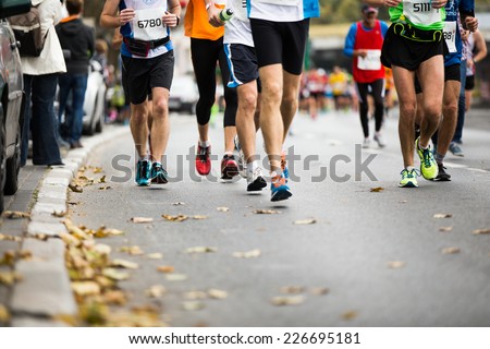 Marathon running race, people feet on autumn road