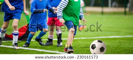 boys kicking football soccer game