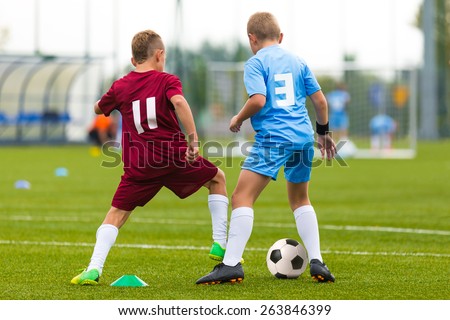 Football soccer game. Running players footballers boys playing soccer match