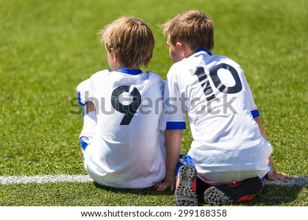 Children football soccer match. Friendship between team mates.