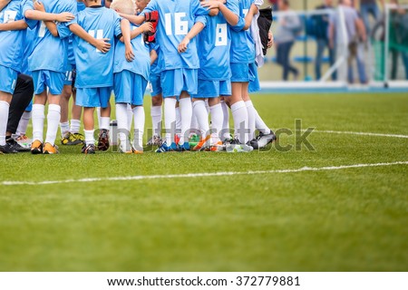 Coach giving children\'s soccer team instructions. Youth soccer team before final game. Football match for children. shout team, football soccer game