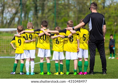 Young boys in soccer team standing united together on the sports field. Penalty soccer game during soccer football tournament for youth european teams.