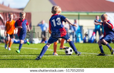 Boys Play Football; Children kicking Soccer Ball; Football Tournament for Youth Sports Teams