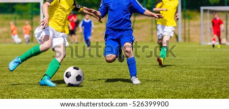 Soccer Players Running and Kicking Ball on Sports Field. Young Boys Playing Football Match on Pitch. Youth Football Tournament Competition